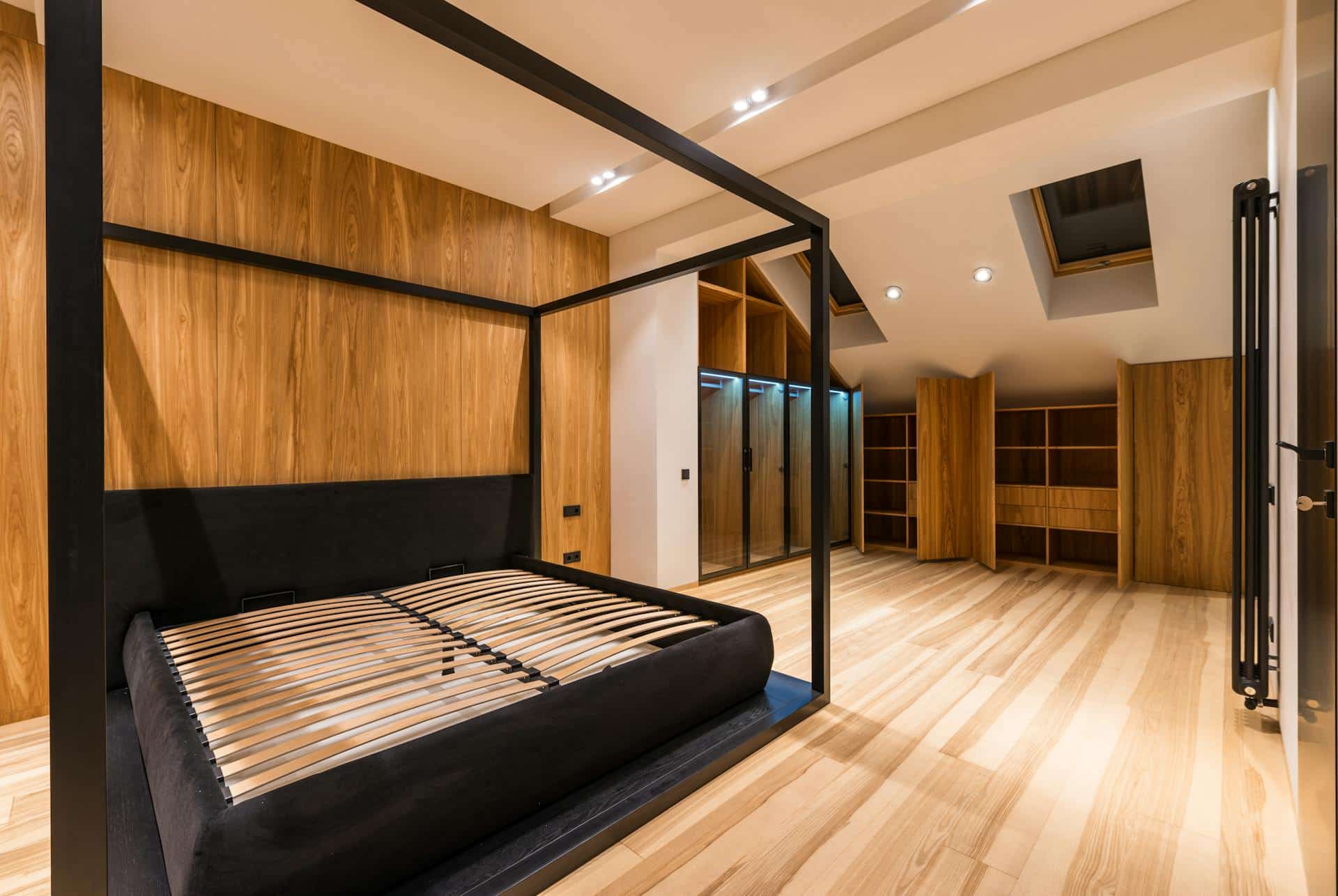 Bedroom with a dark timber four-poster bed and a slatted wood feature wall