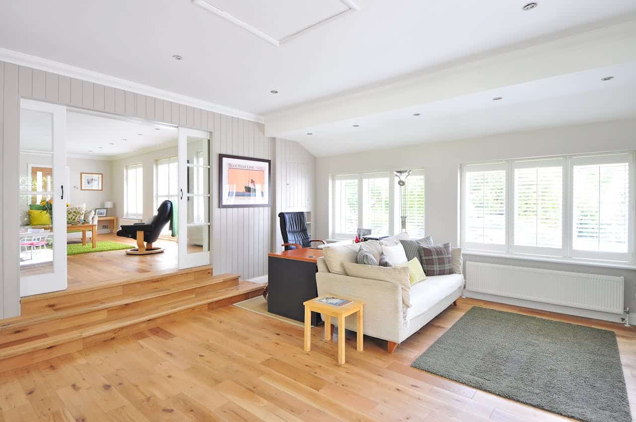 Bright living room with hardwood floors and an open sightline through to the next room
